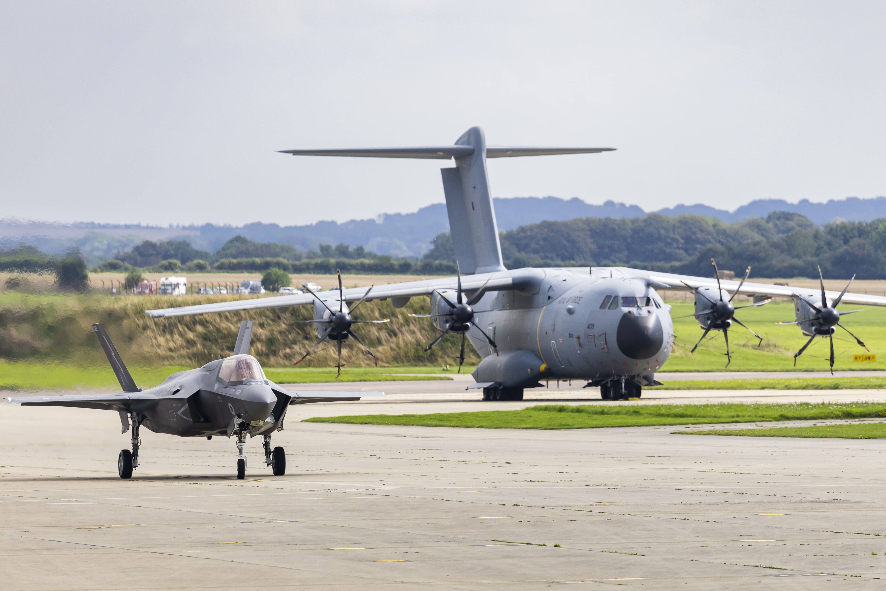 An RAF F-35B and A400M on a runway together.