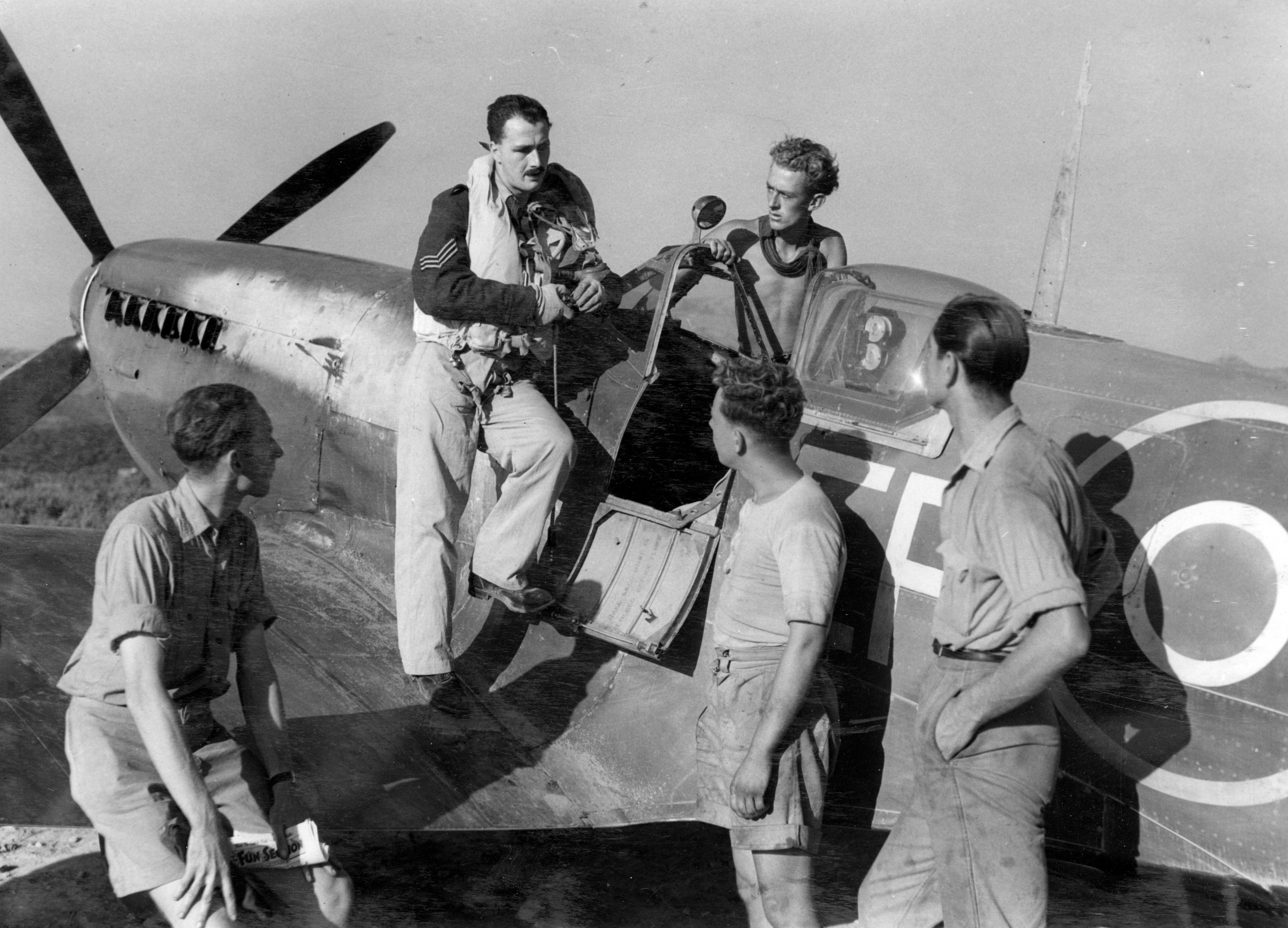 A Spitfire pilot with 232 Squadron at Calenzana on Corsica, telling his mechanics and ground crew what he saw during patrol.