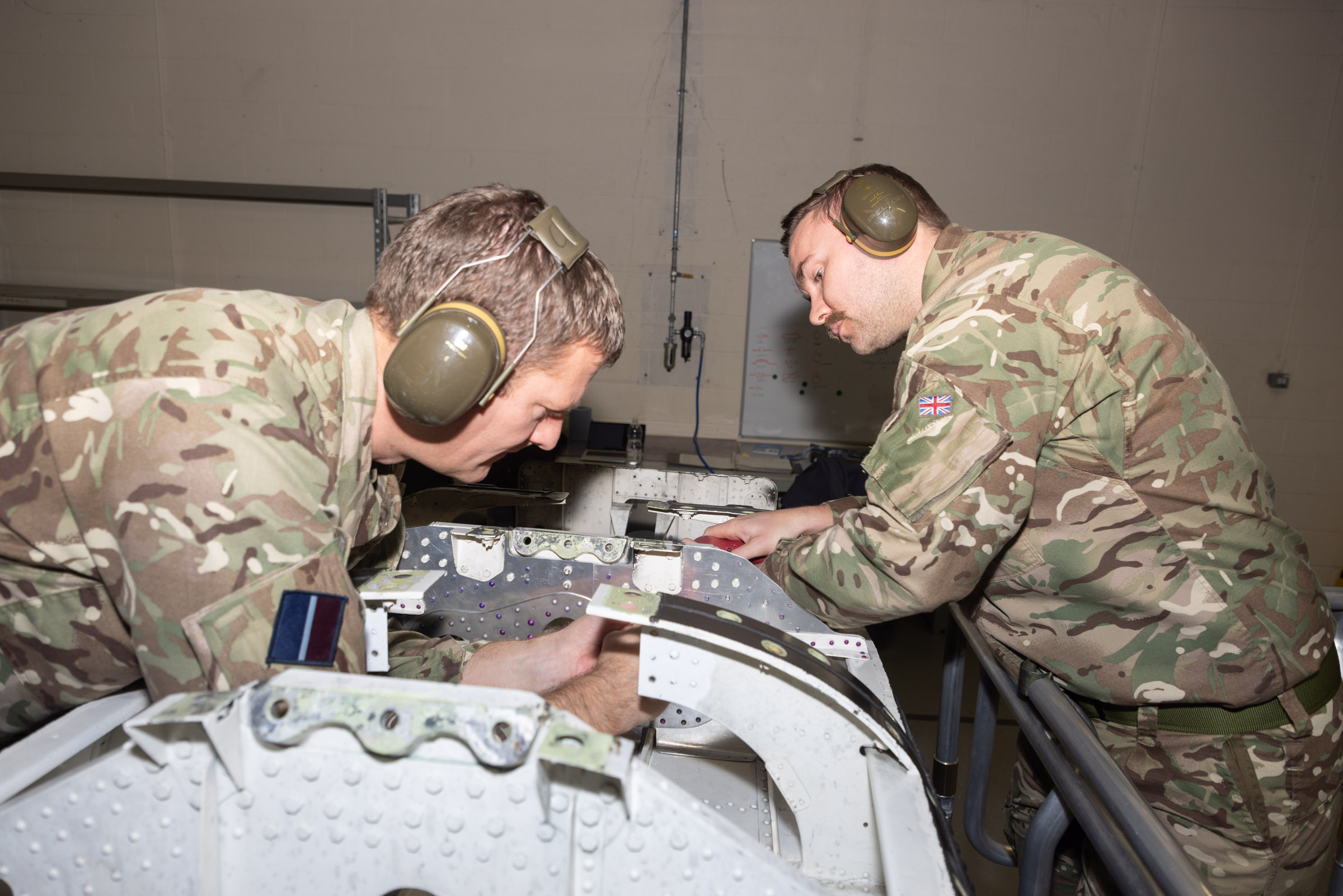 Two RAF personnel with repairing equipment.