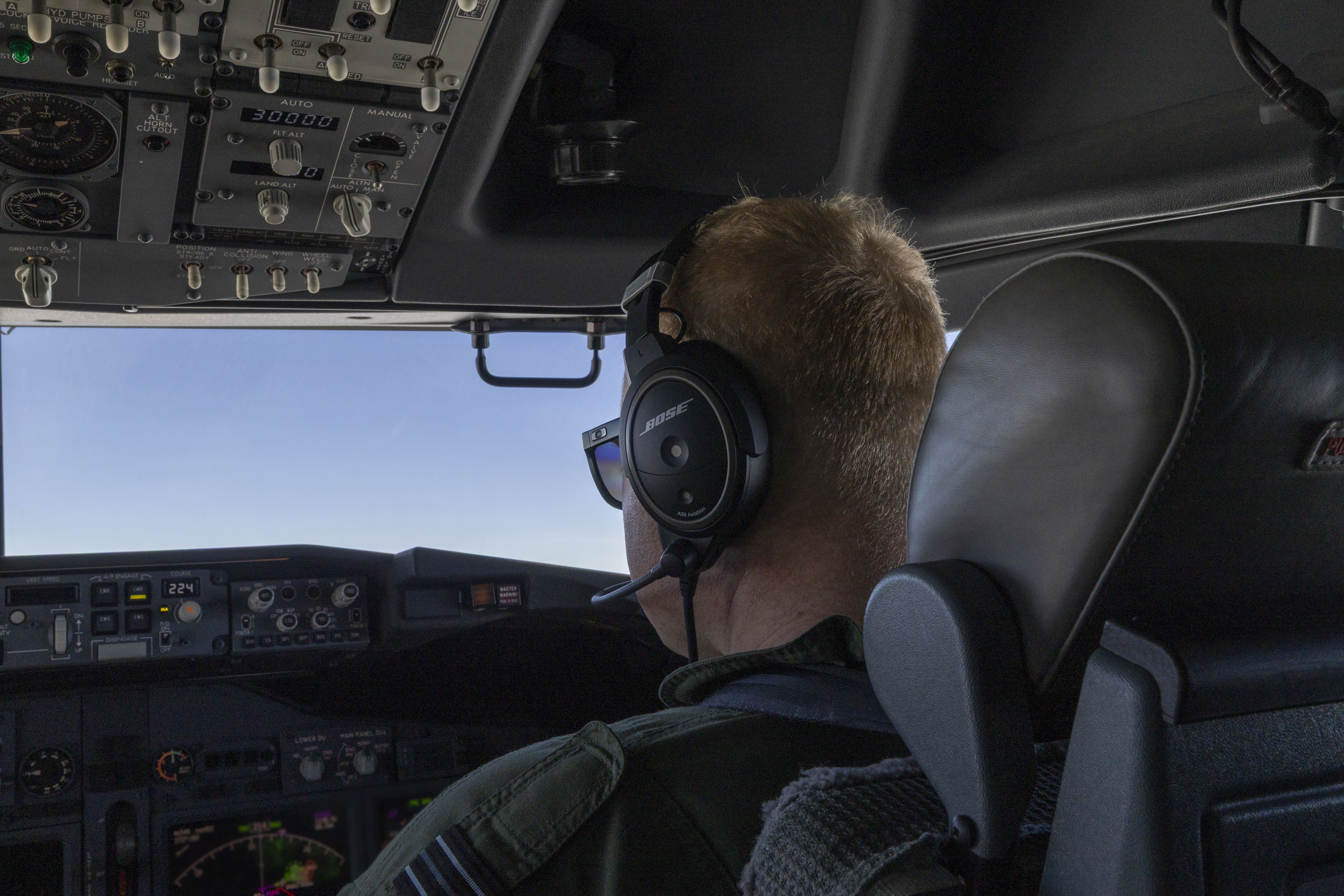 An RAF Poseidon pilot in the cockpit of the aircraft.