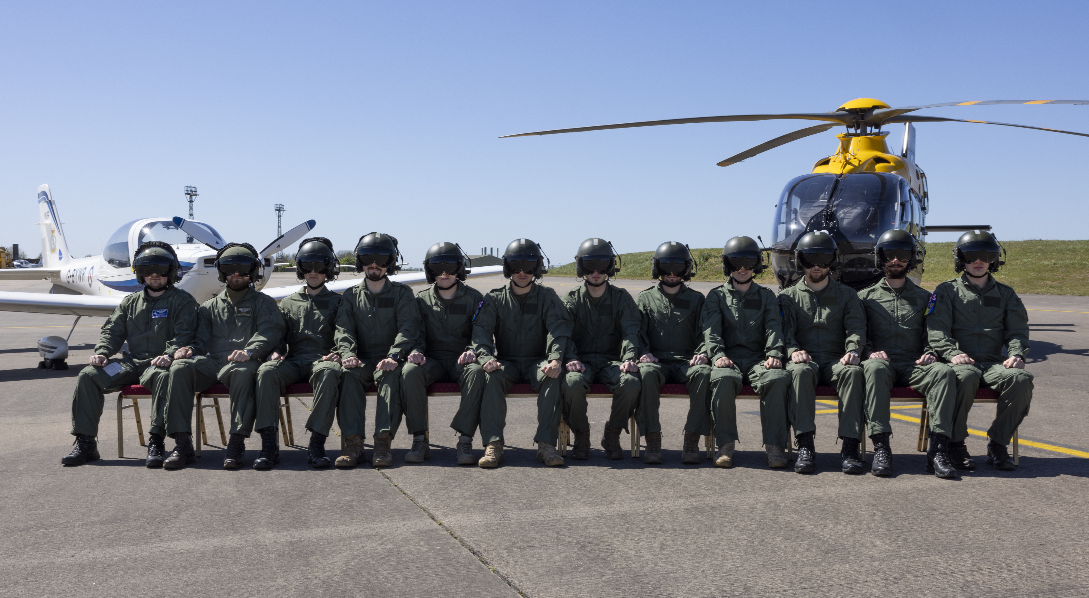 Ukrainian aviators sat in a row at a graduation from the RAF's Elementary Flying Training Programme.