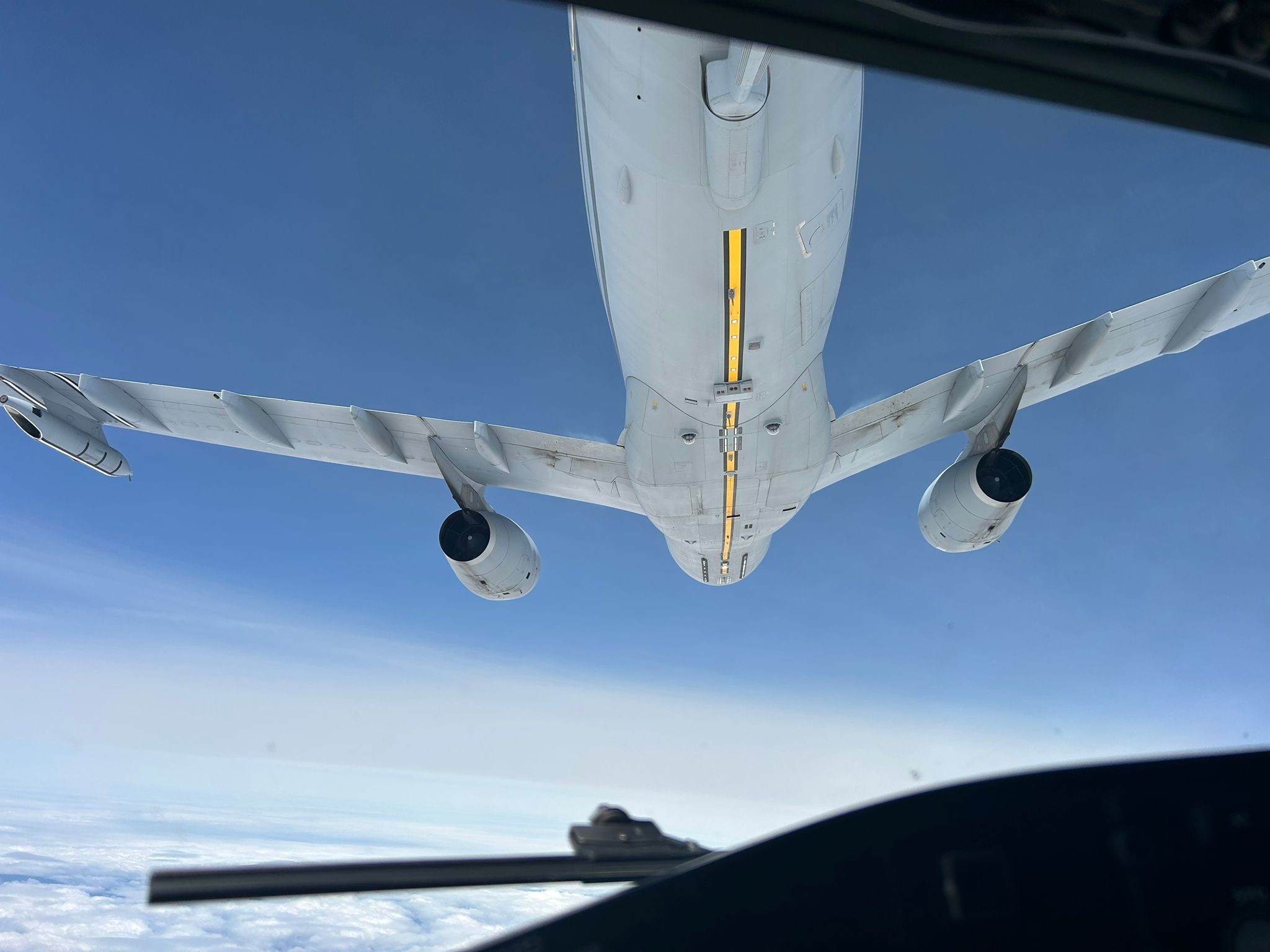 Cockpit view of an RAF Rivet Joint beneath a French air-to-air refueller.