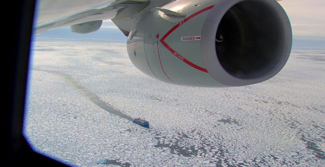 An image taken from an RAF Poseidon of a ship navigating through ice.