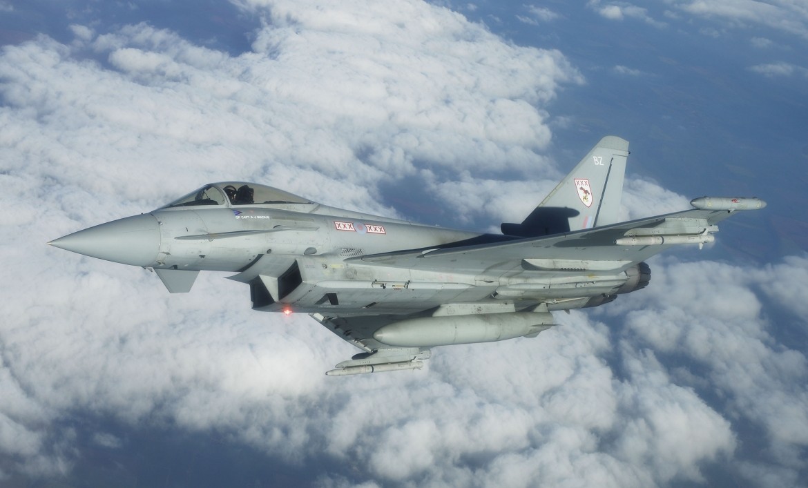 A Royal Air Force Typhoon mid-flight above clouds.