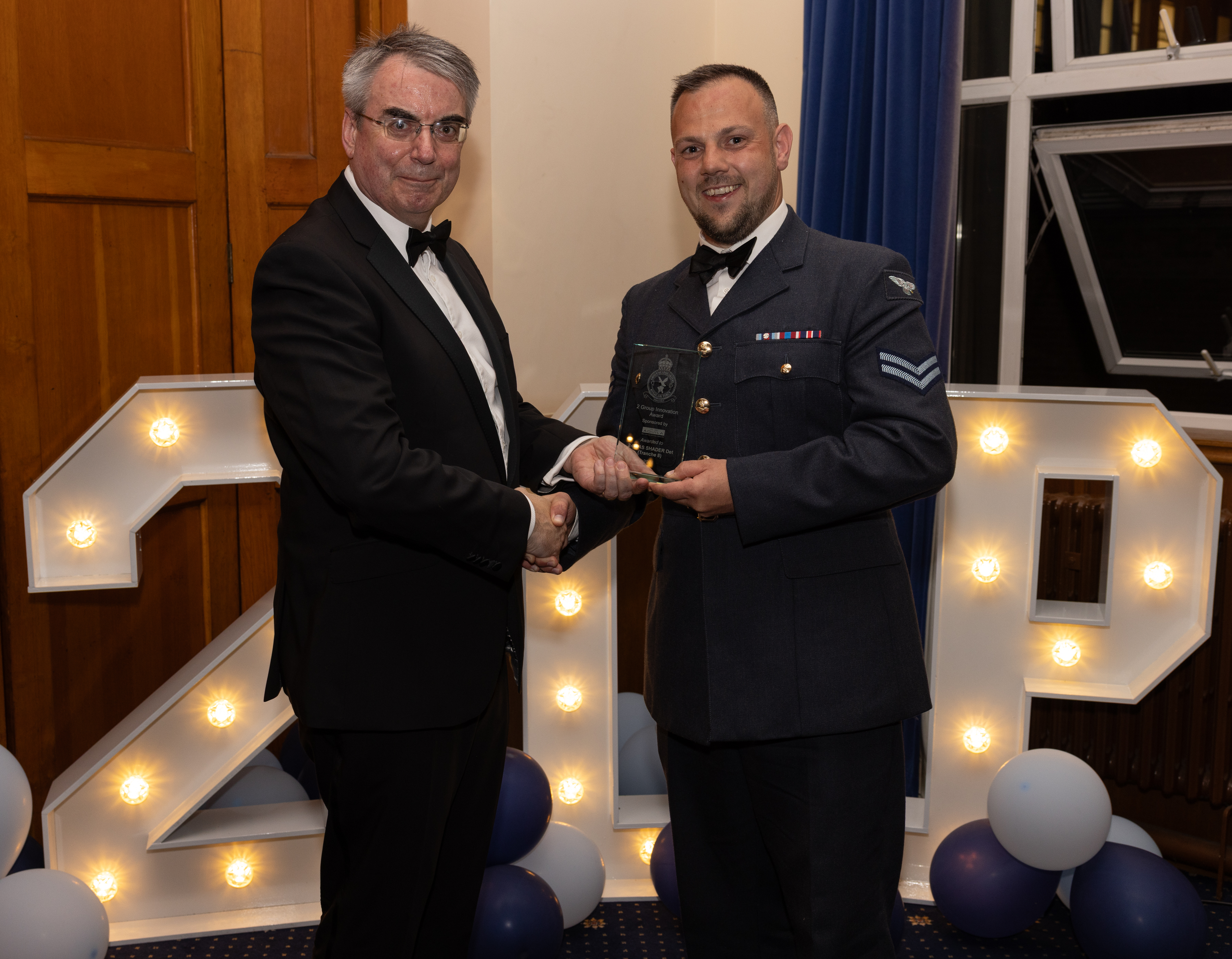 Cpl Blair receiving the No.2 Gp Innovation award presented by Peter Hitchcock from Aquila
