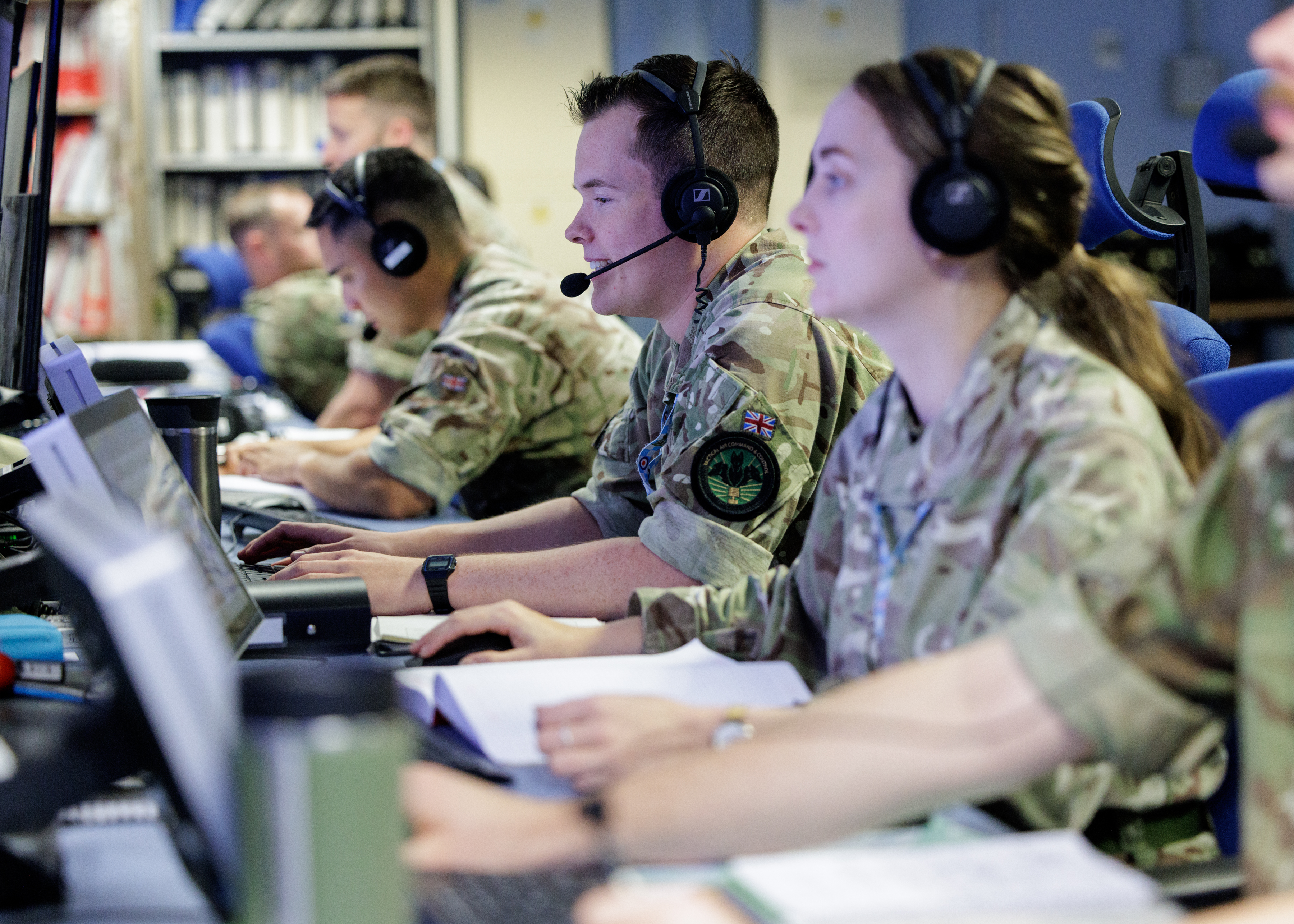 An RAF serviceperson operating battlespace management technology whilst sat at a screen.