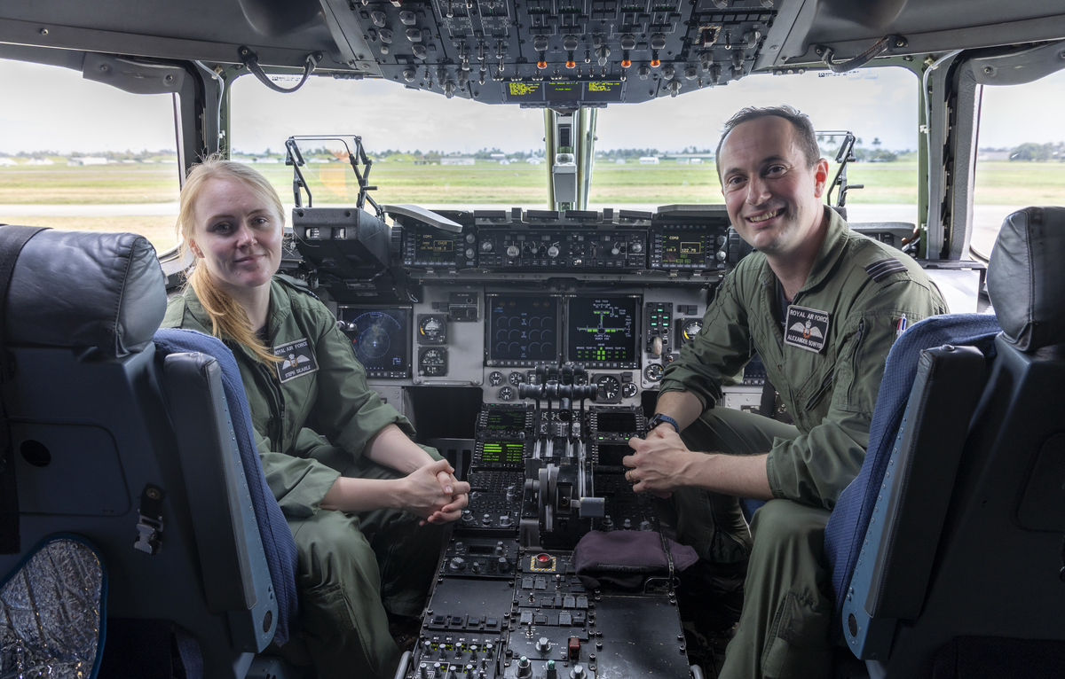 Flt Lt Bowyer and Flt Lt Searle sit in the cockpit of an aircraft