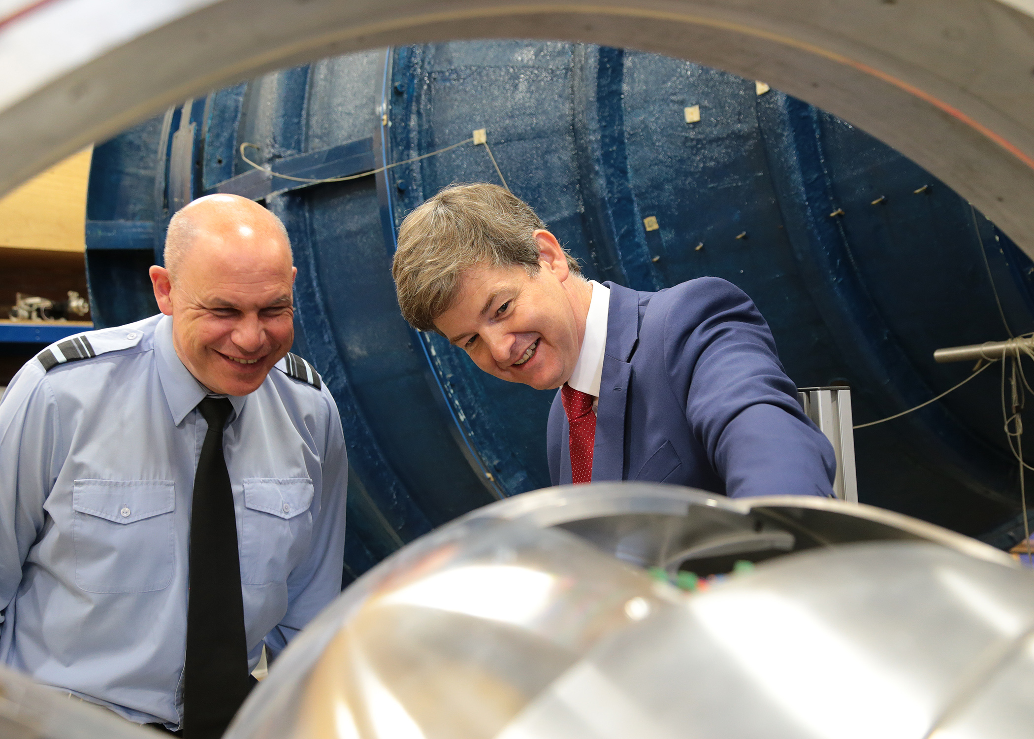 2 men looking at aviation equipment