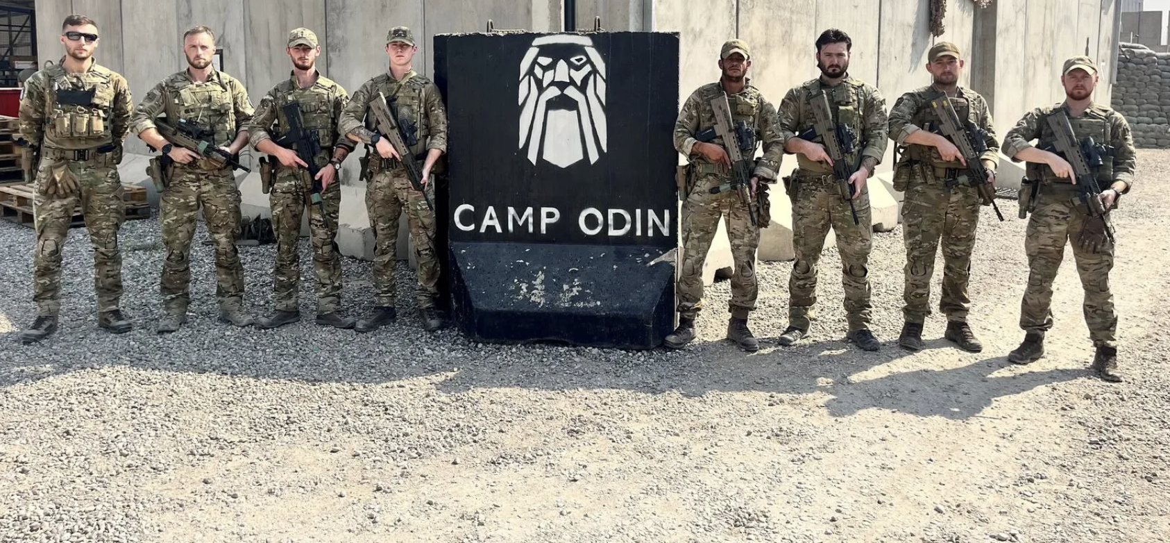 Personnel standing by a statue. 