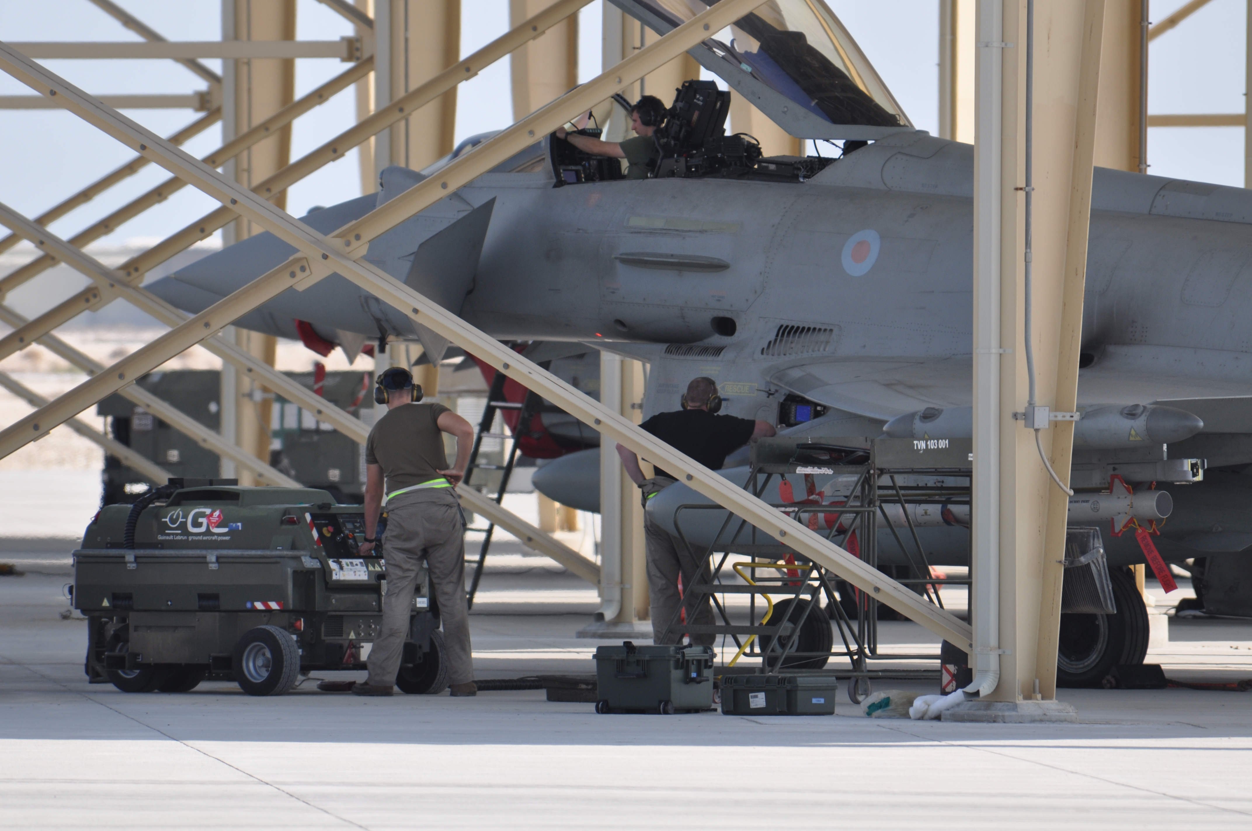 Engineers at work, with aircraft in the background