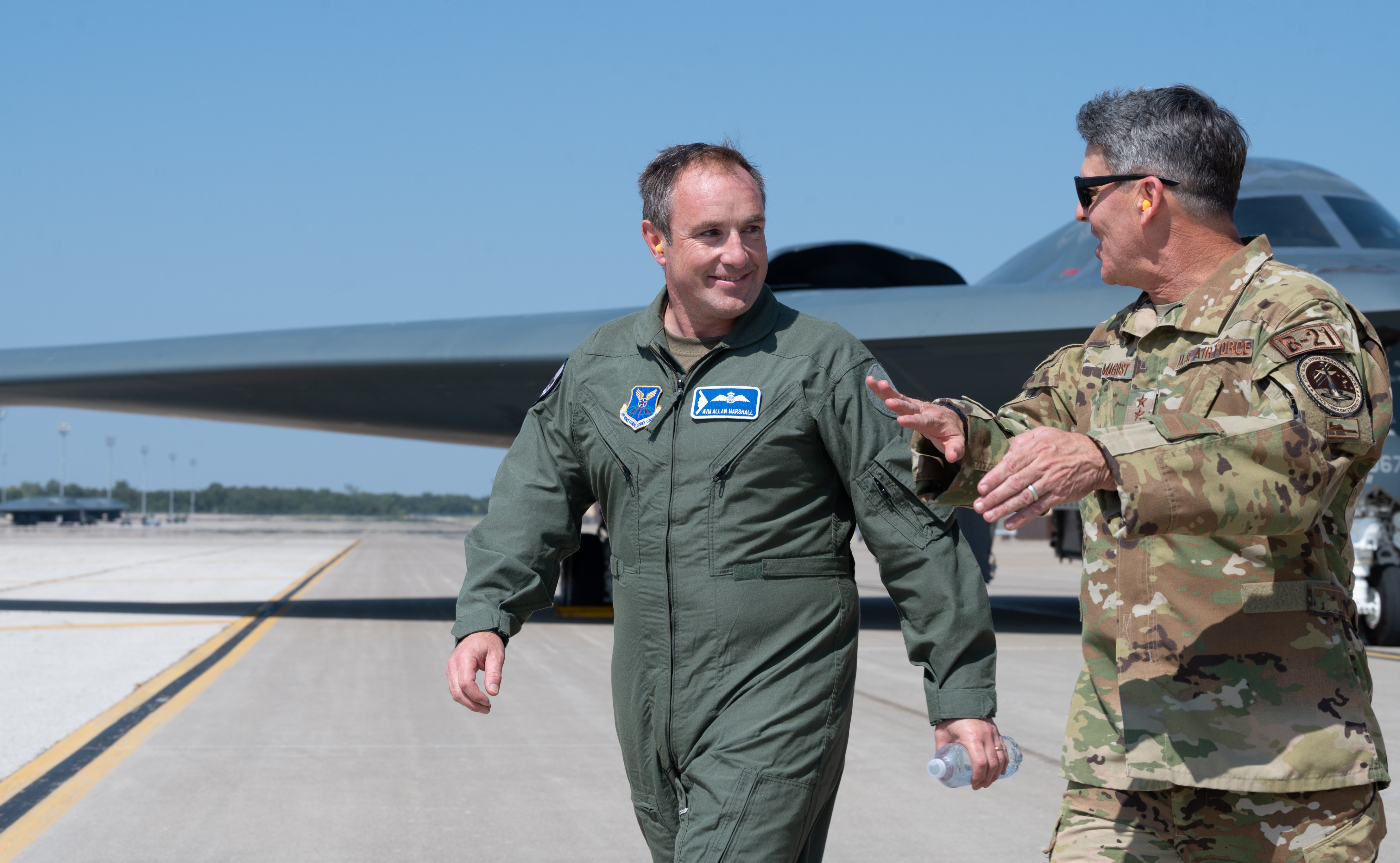 Marshall (left) and Armagost (right) on a runway chatting
