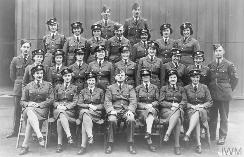 Black and white photo of squadron sat on chairs. 