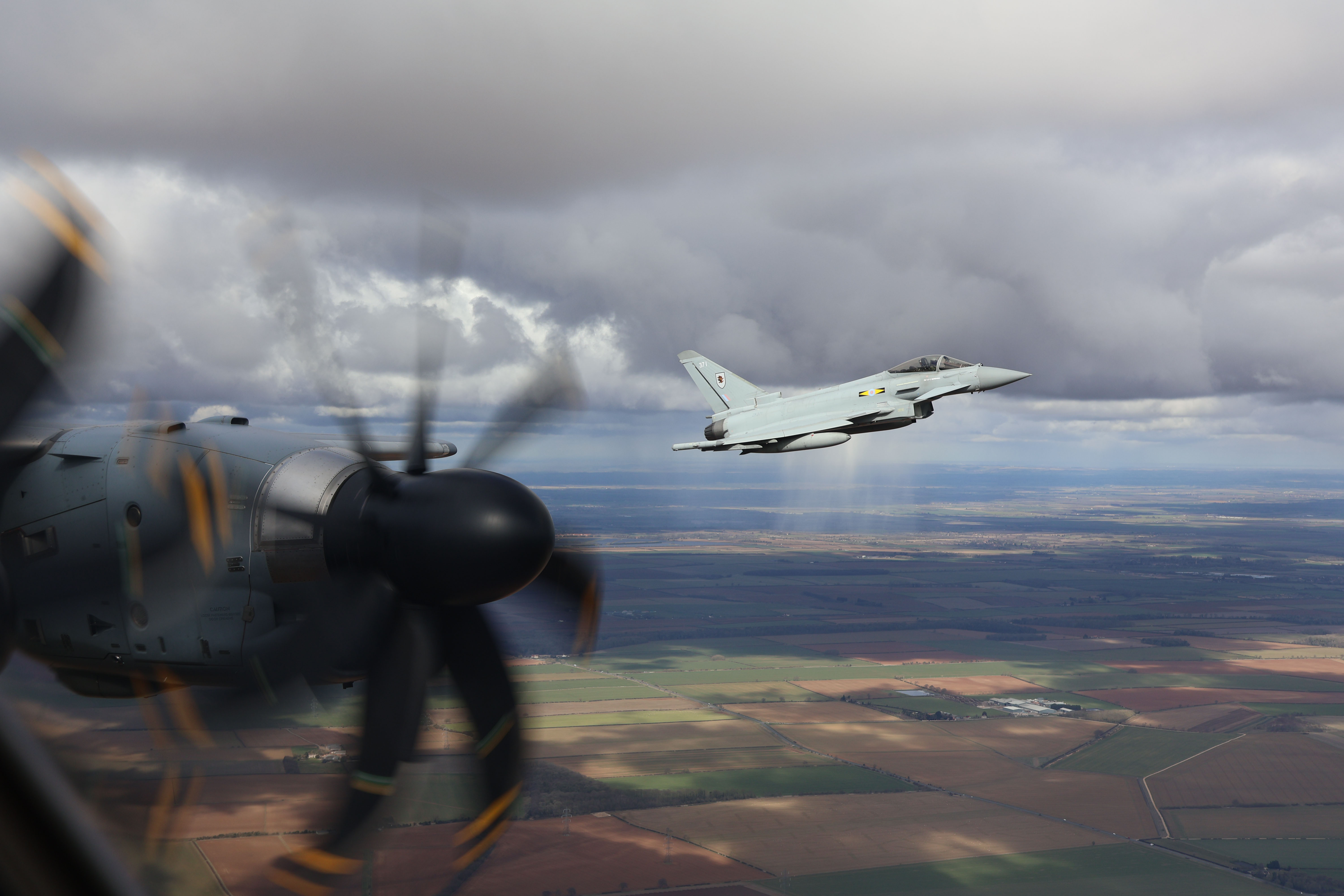 Typhoon flying over fields, taken from inside an Atlas.