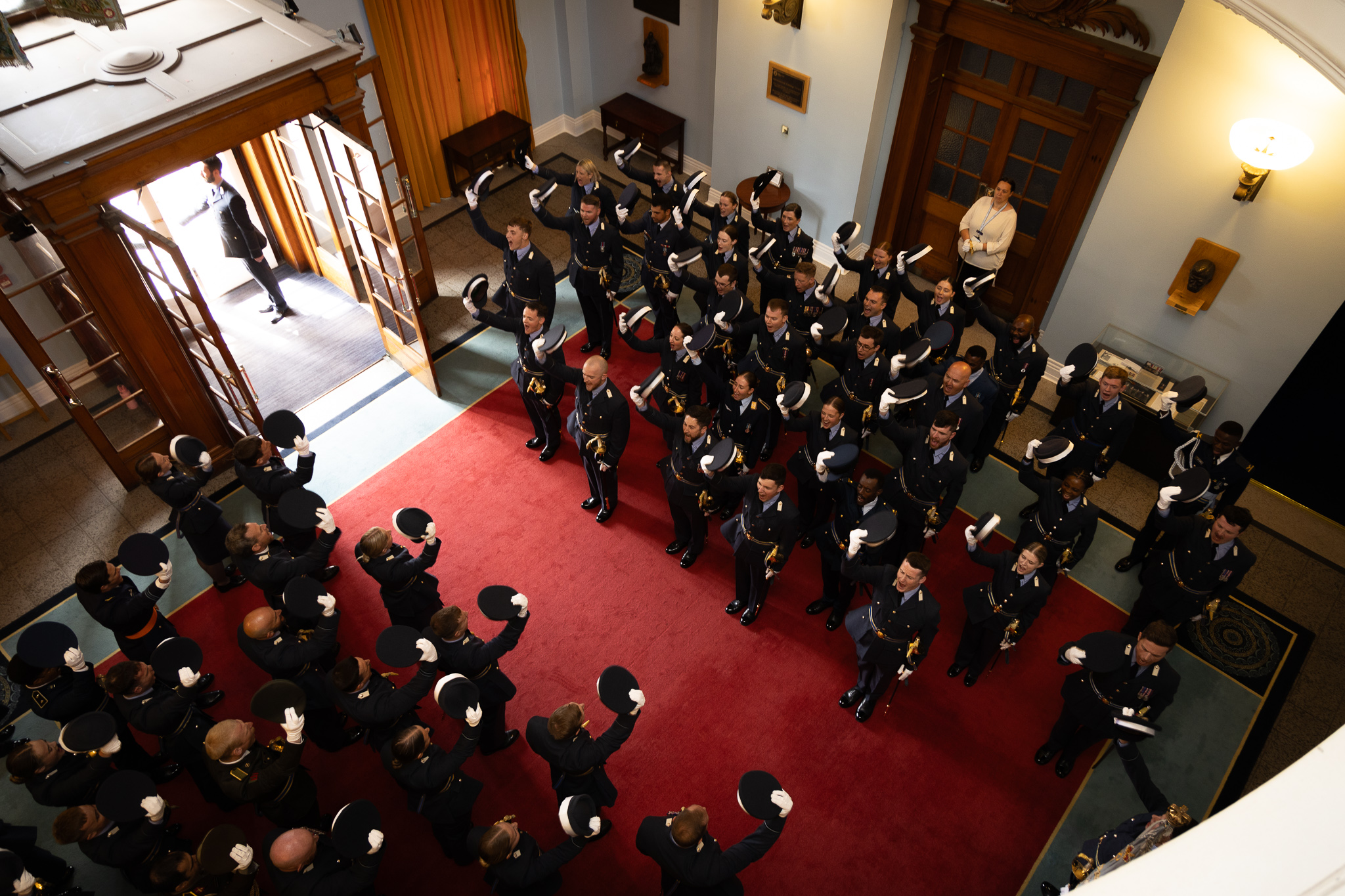 cadets raising their hats 