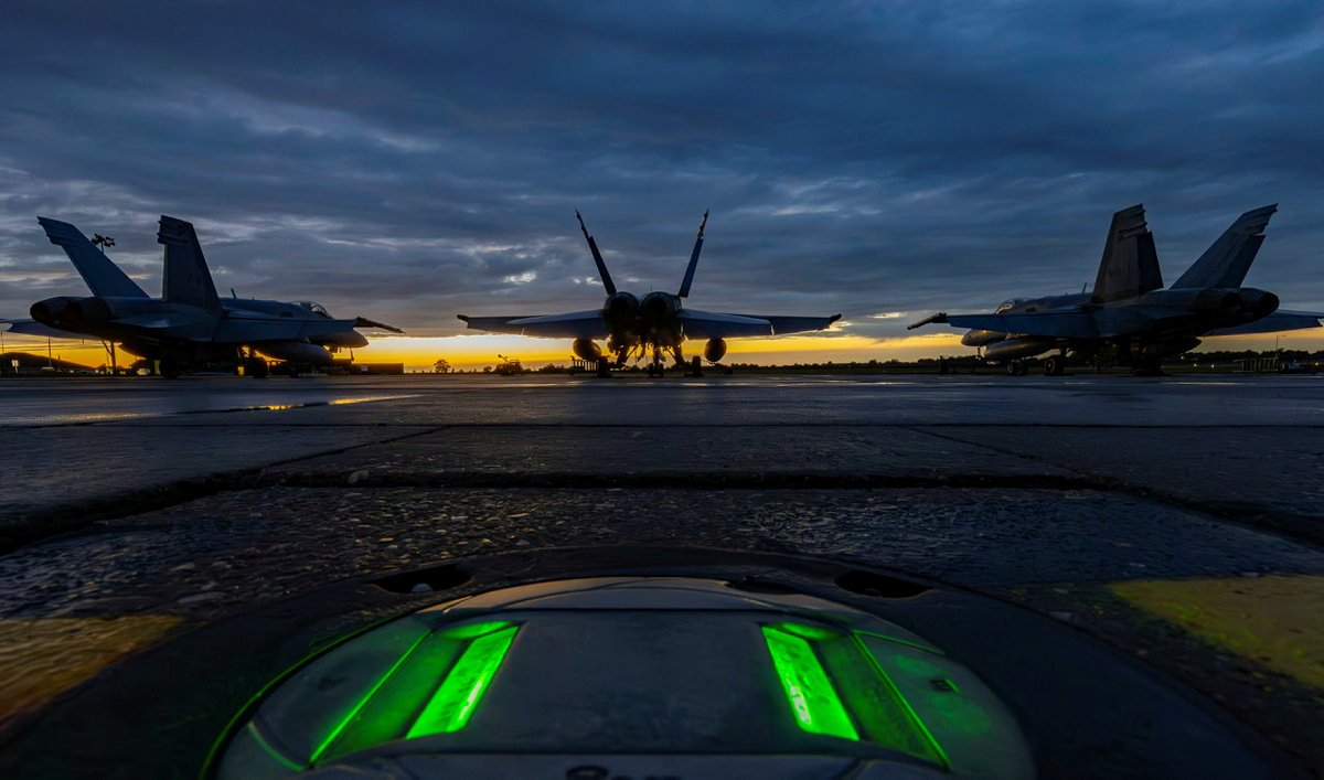 Canadian F-18 aircraft on the runway at night