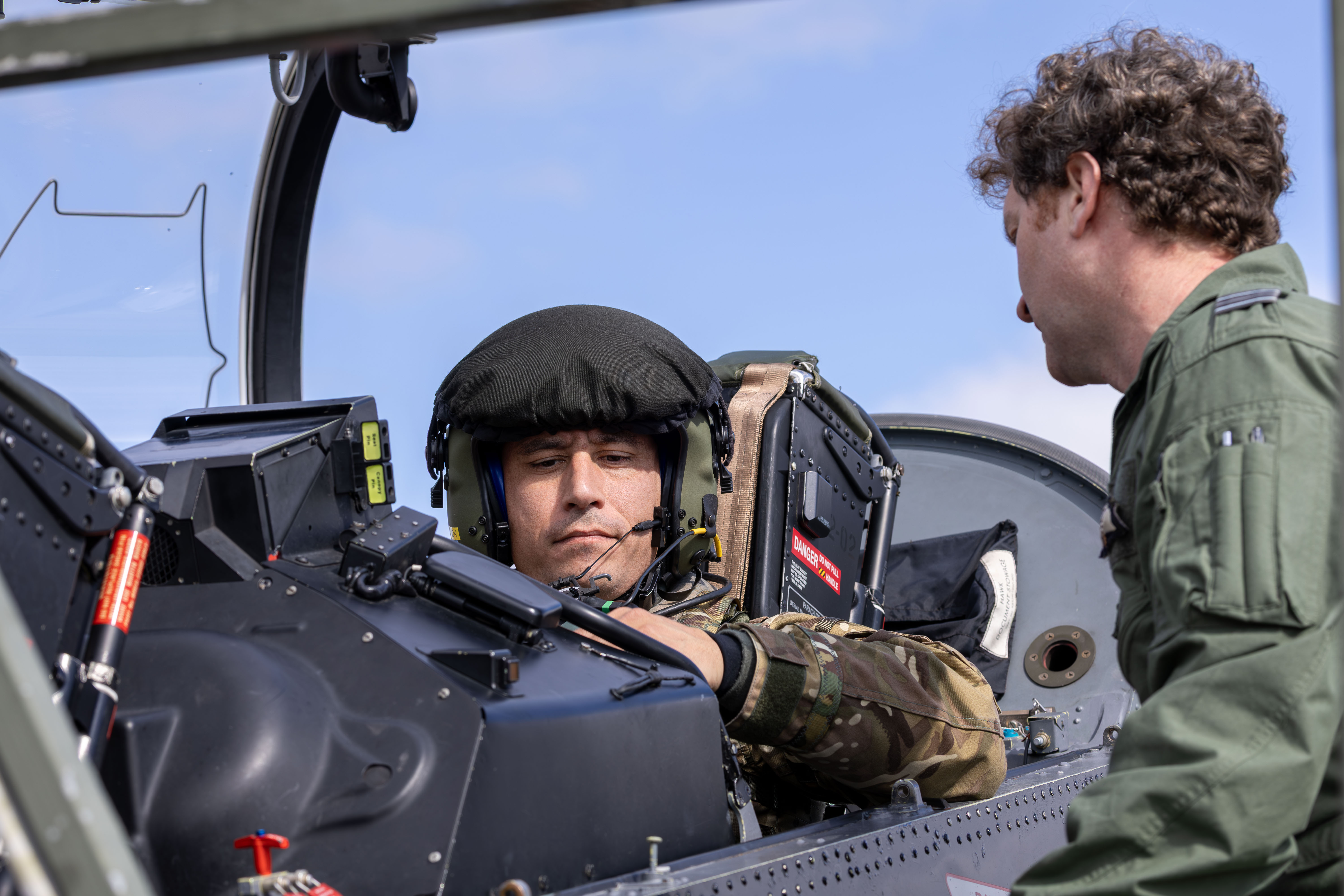 Two members of the RAF undertaking final checks on a Typhoon before take-off.