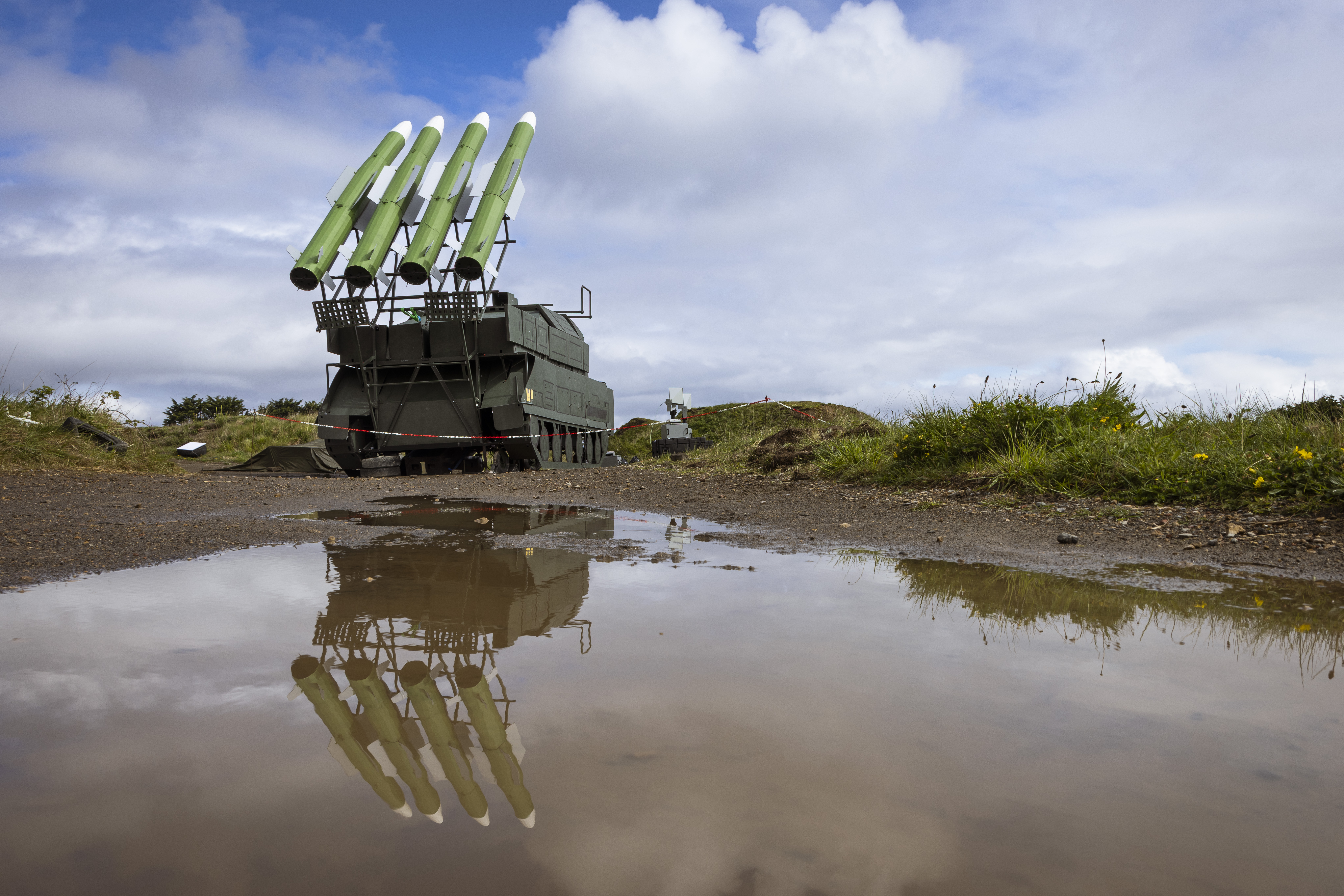 An image of the Sting training capability system, with its reflection visible in the surface water in the foreground.