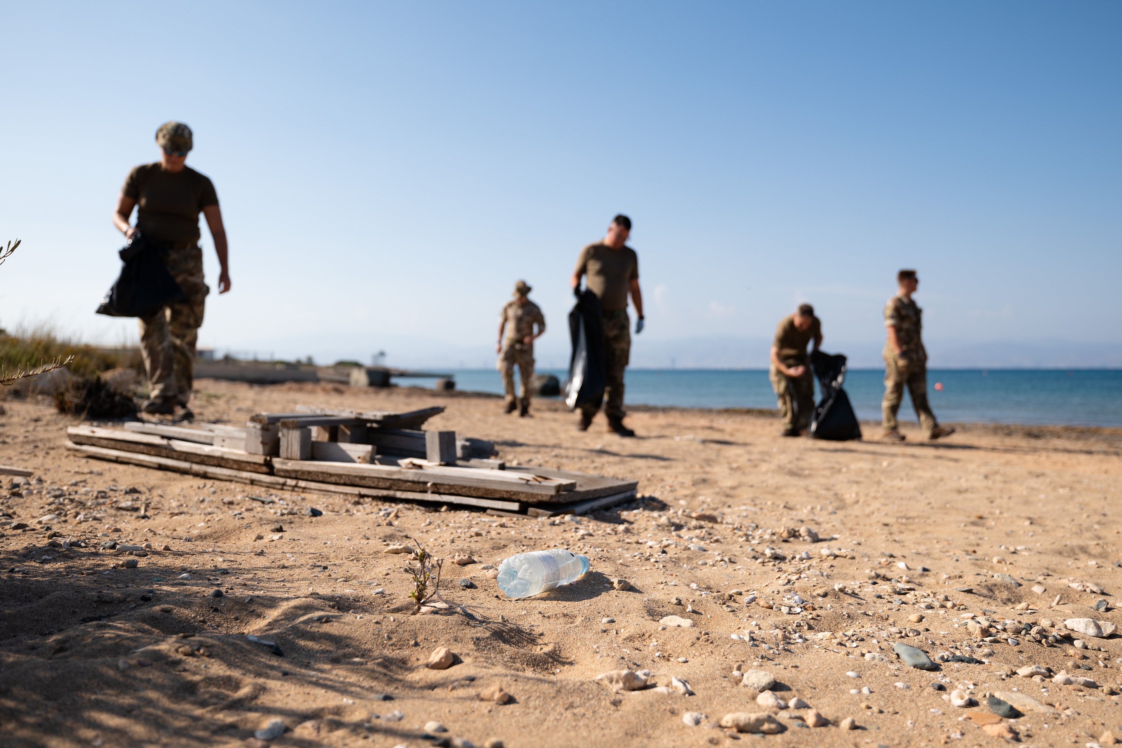 Personnel cleaning up on the beach.
