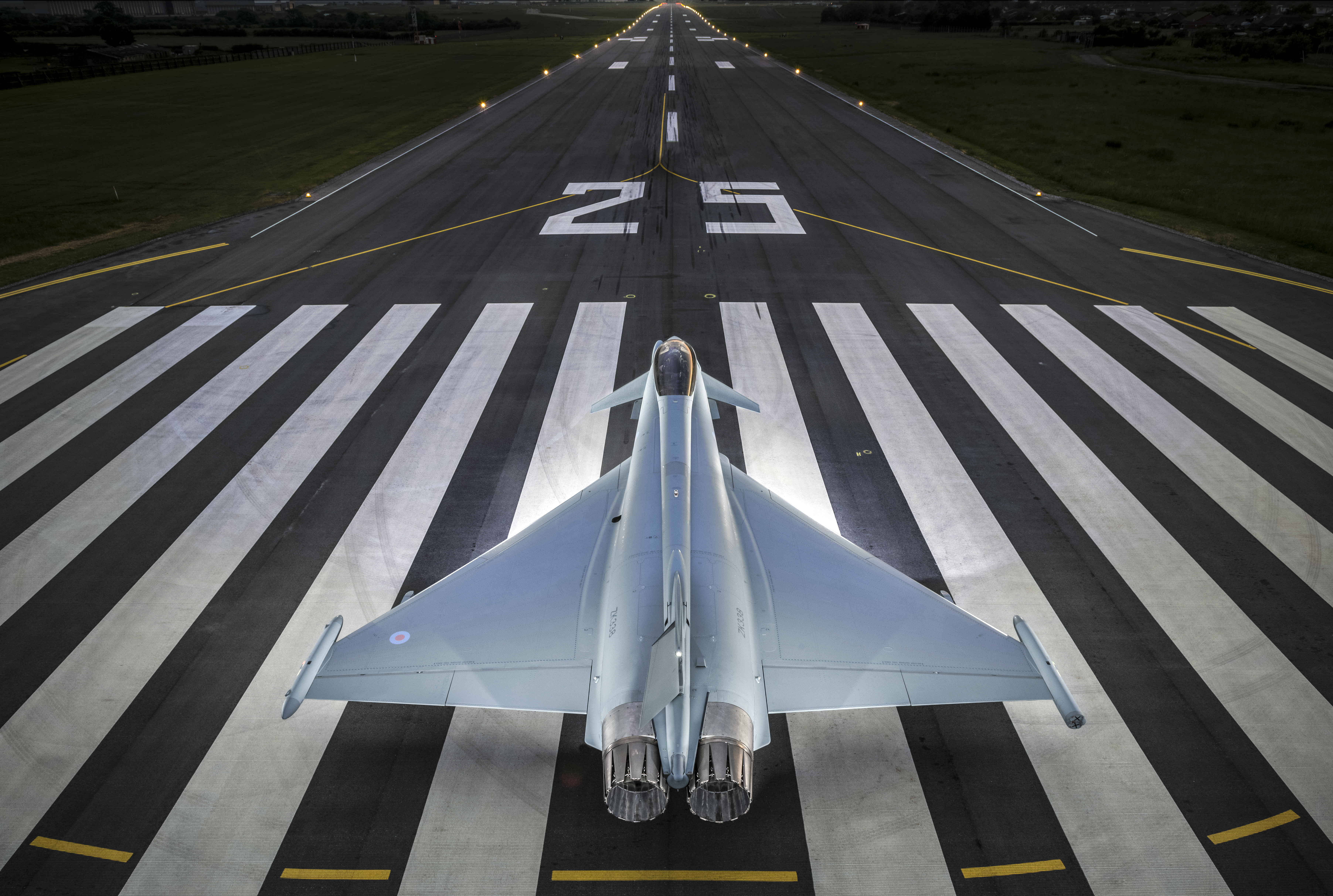 Picture of an RAF Typhoon from behind as it is parked on a runway.