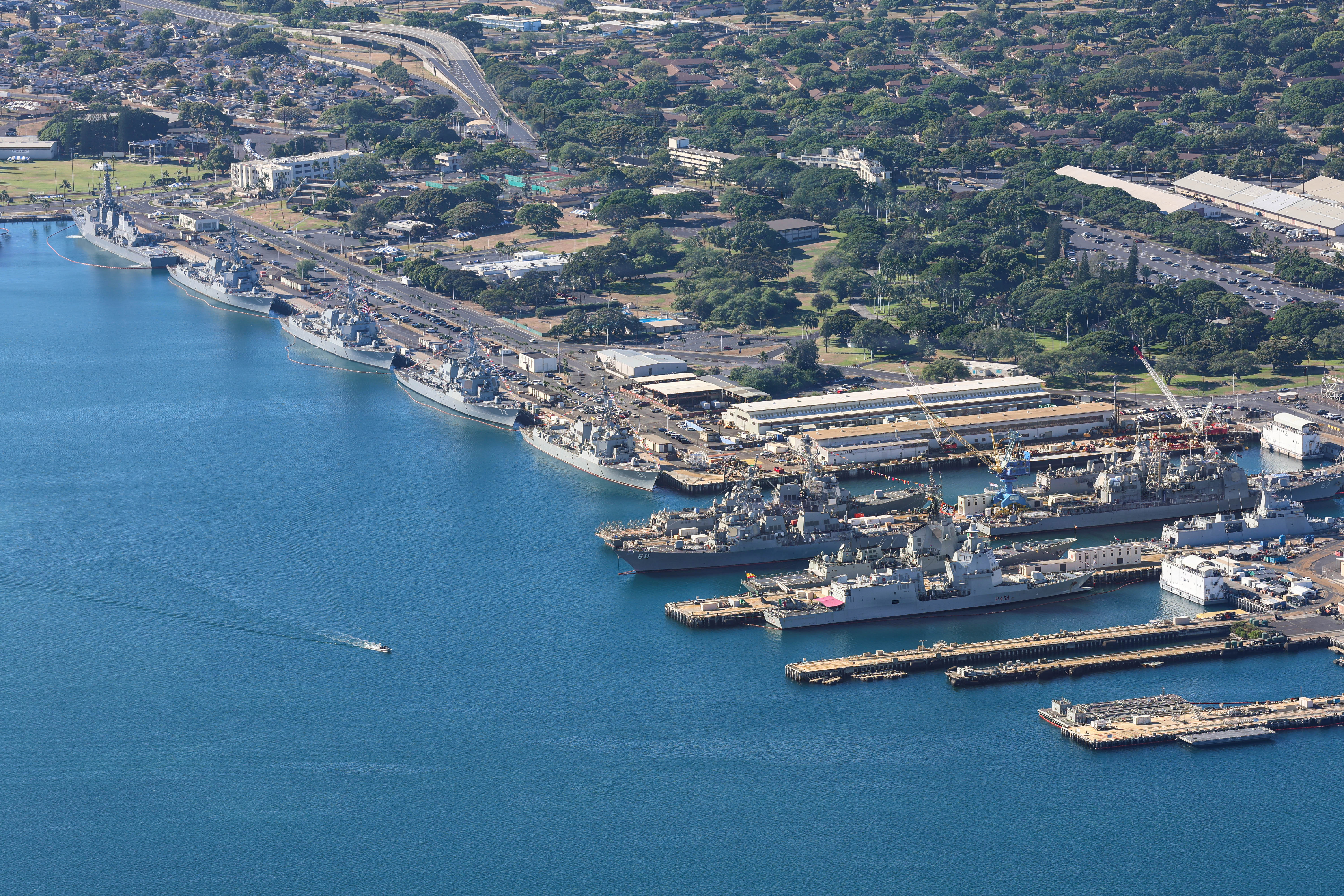 Multiple ships harboured on Ford Island in Hawaii.