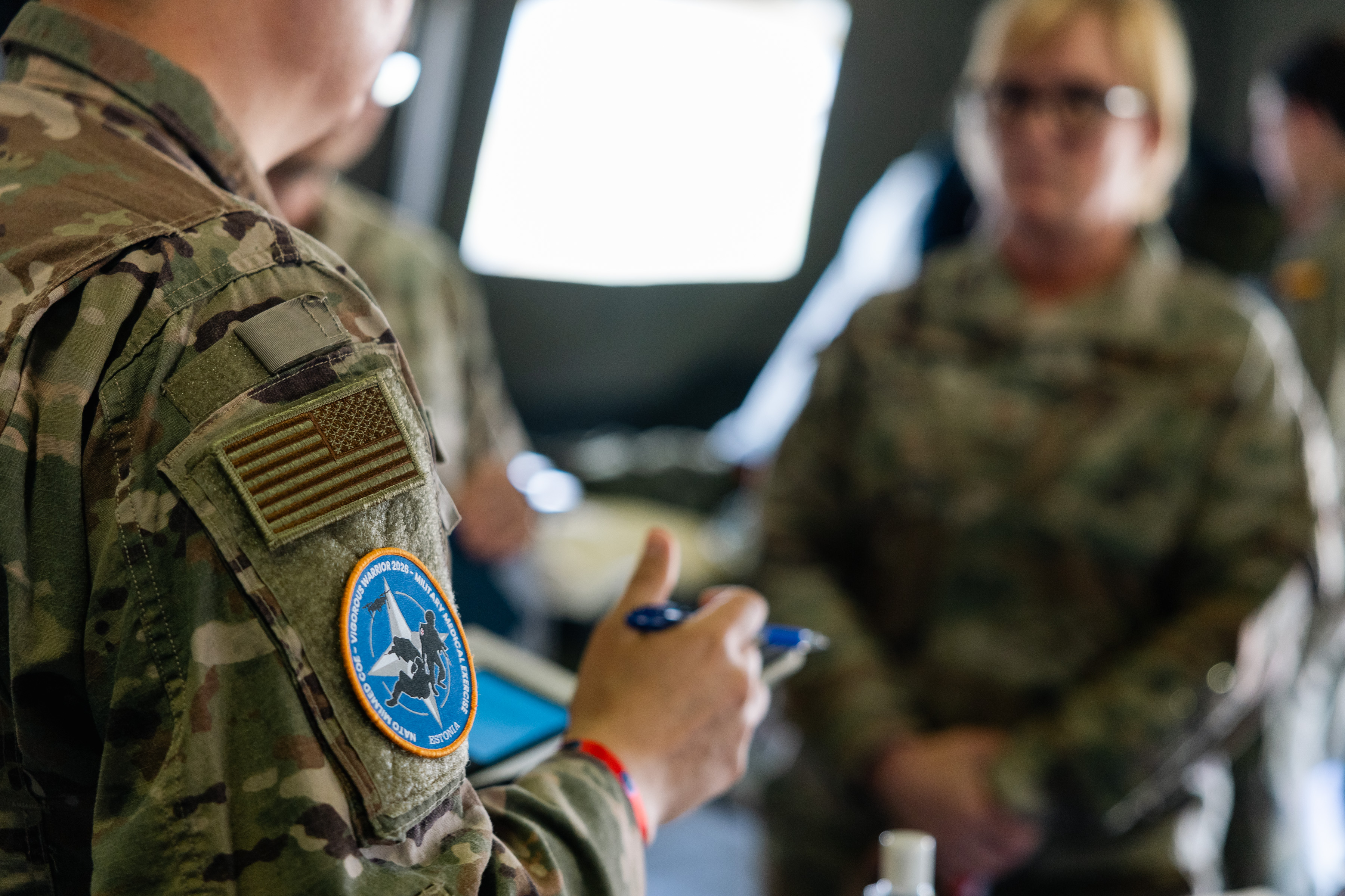 Closeup of an American serviceperson's patches: one of the US flag, and one designed for Vigorous Warrior 2026.