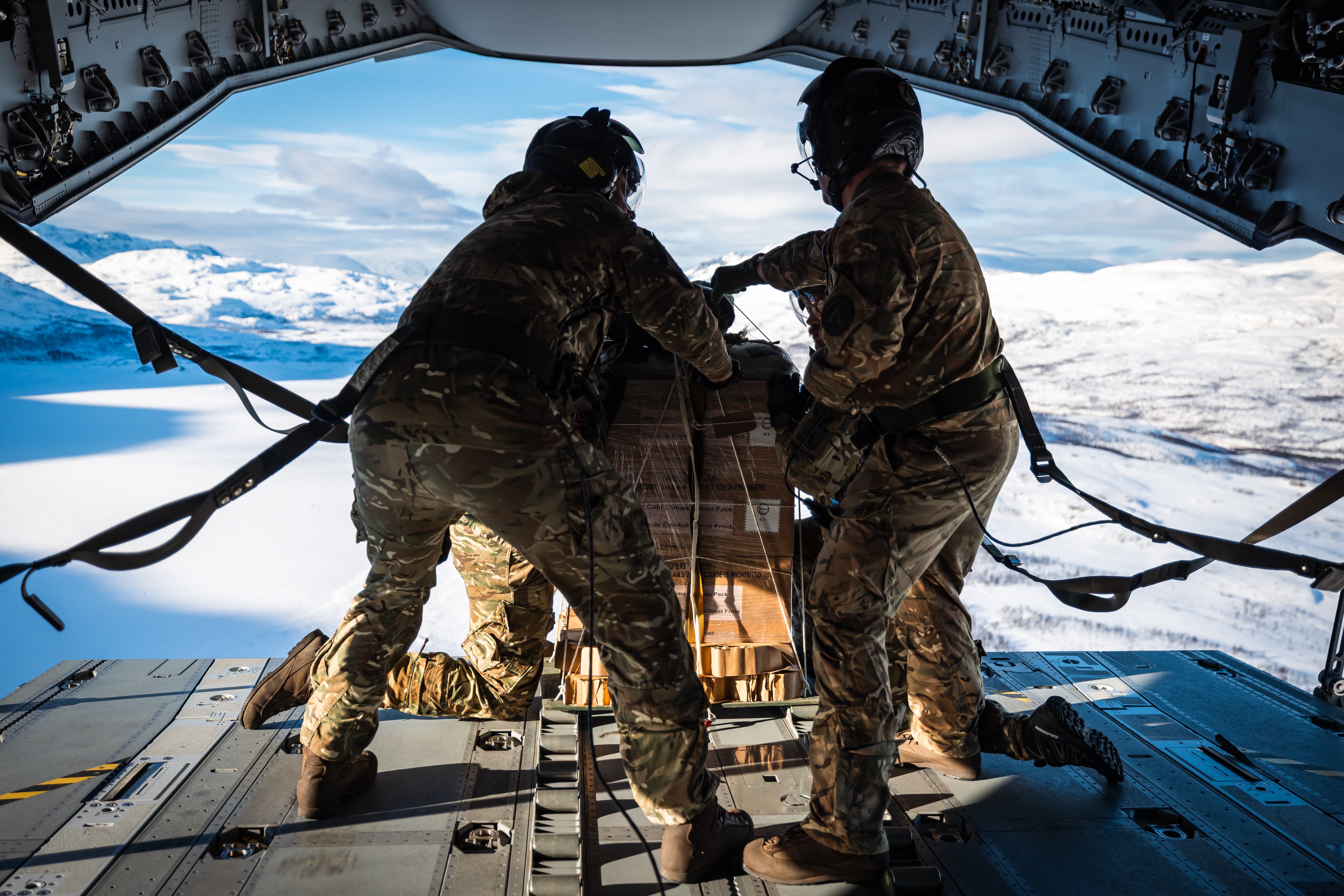 RAF personnel preparing to drop supplies out of the back ramp of an A400M Atlas.
