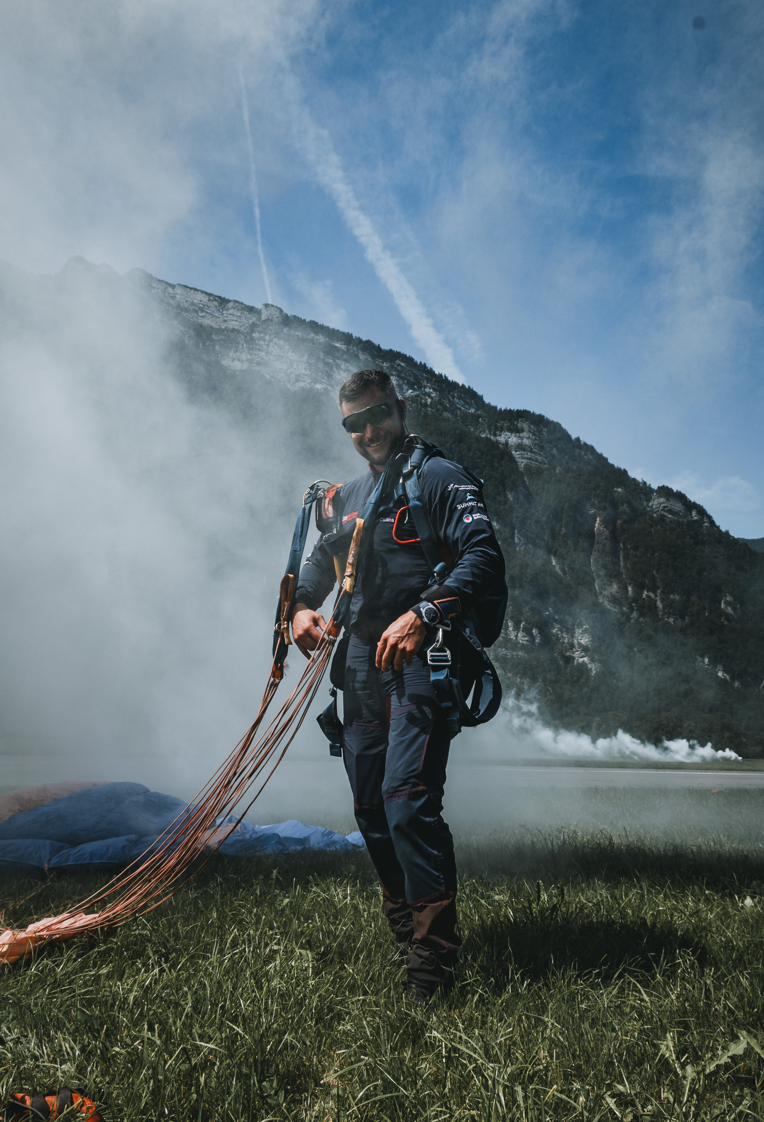 Parachutist after landing amid smoke