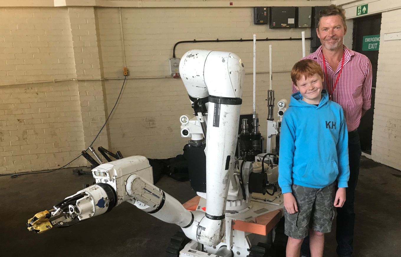 Guy Greenway and his son with the Cutlass robot