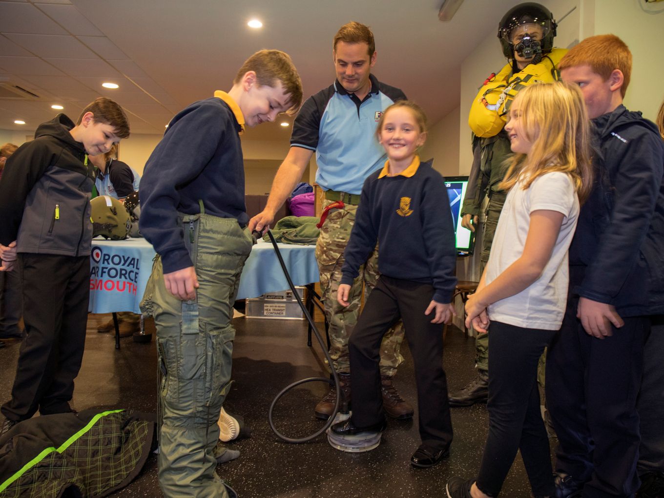 School children try on a fast jet pilot's 'g-suit'