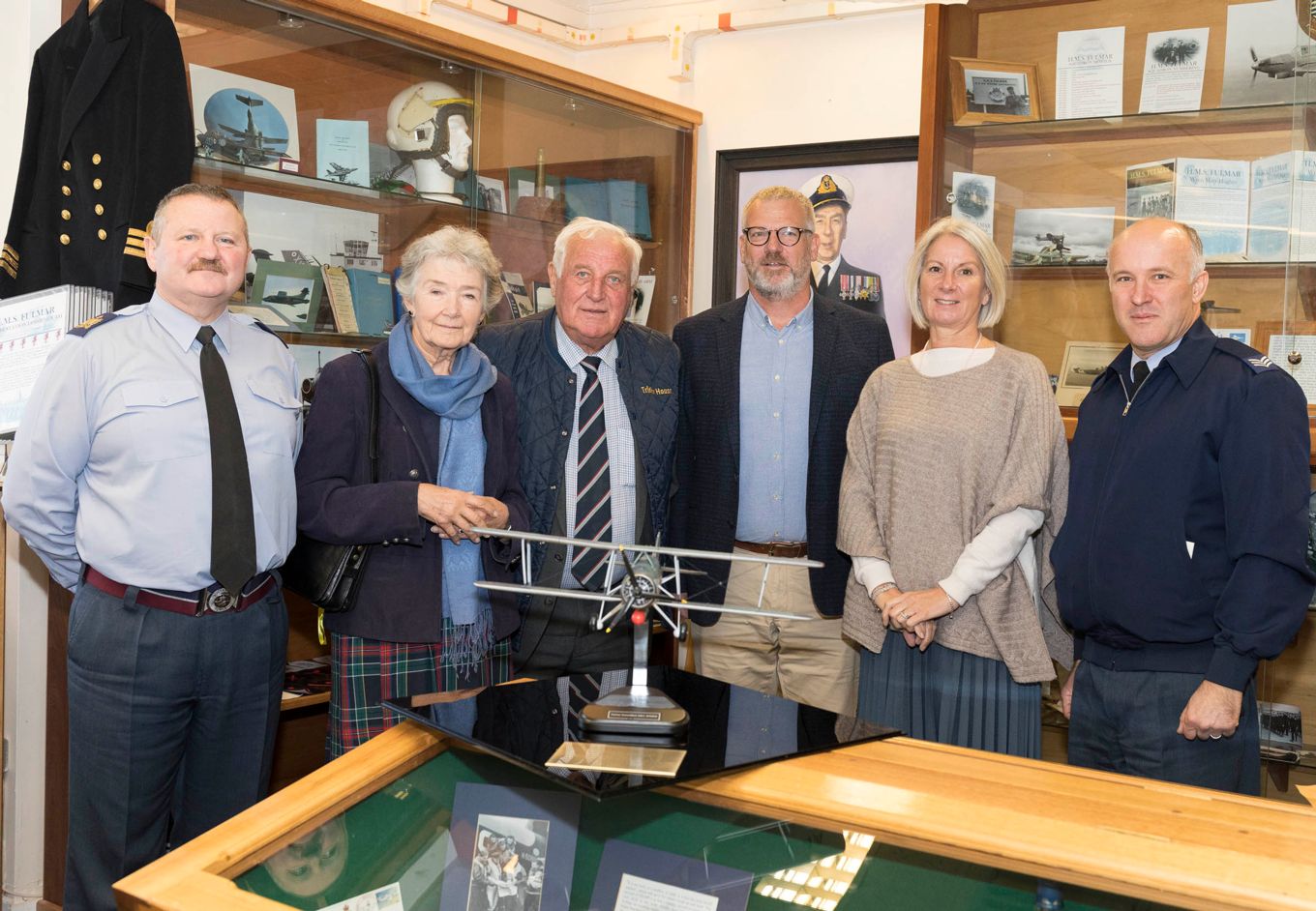 Members of the Stephens family donate a model aircraft to RAF Lossiemouth personnel