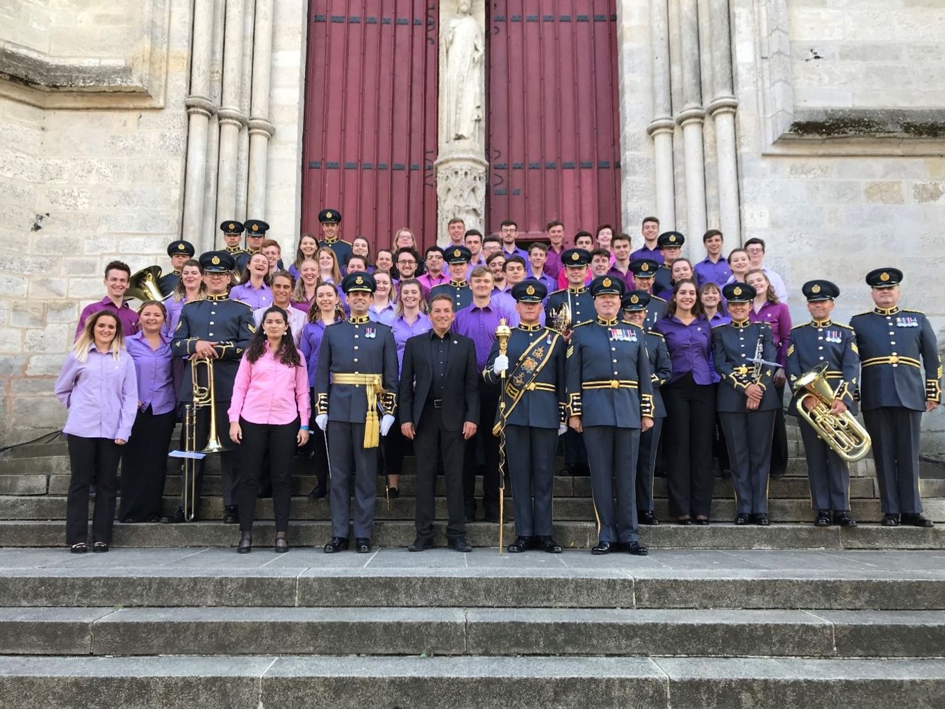 People pose for a photograph on the steps of Amiens Cathedral.