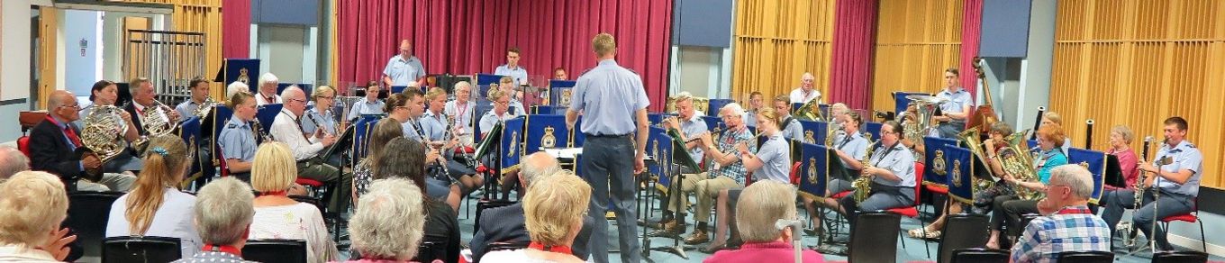 Uniformed and non-uniformed musicians of all ages play music together.