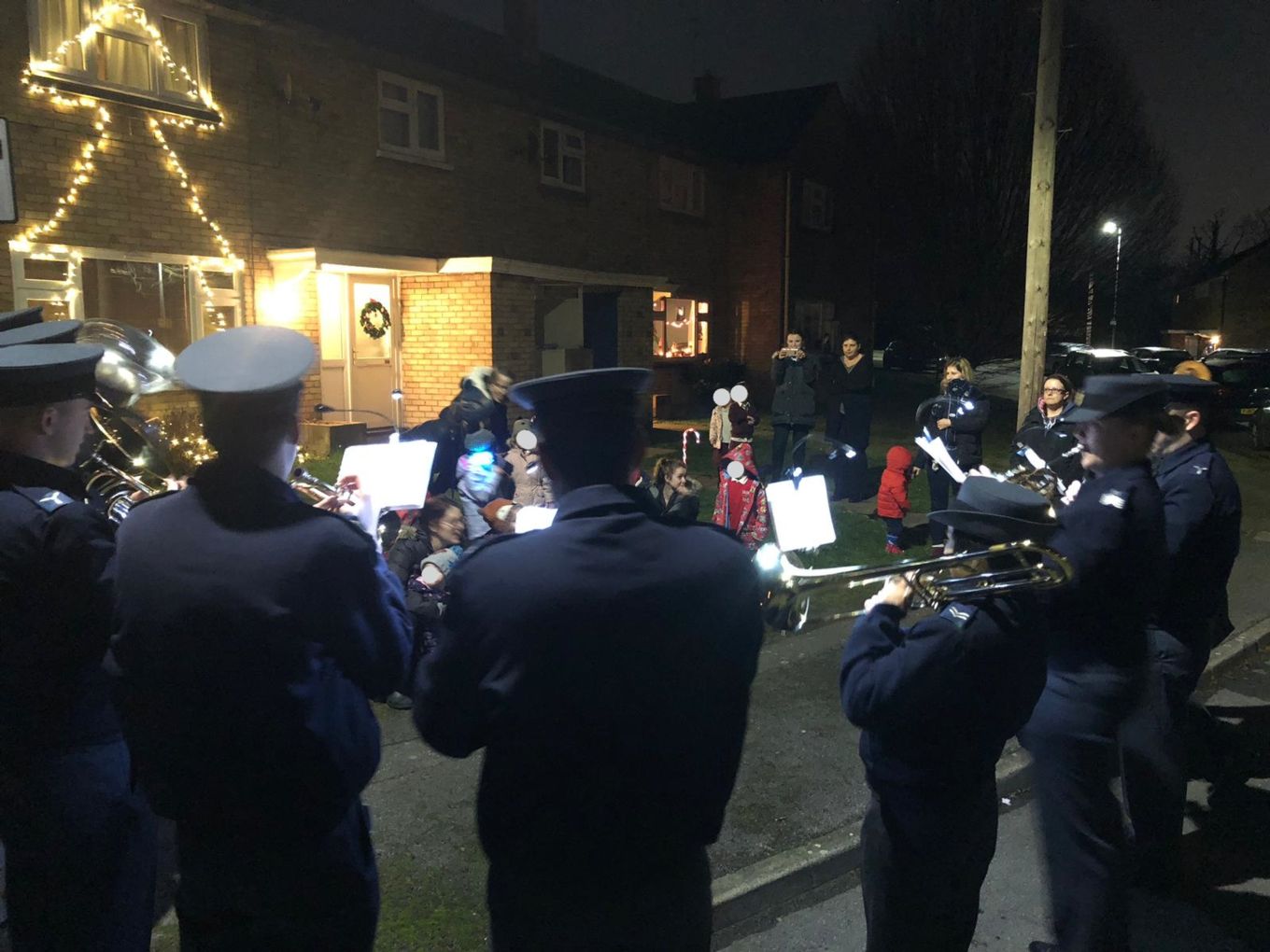 RAF Musicians play Christmas carols to families.