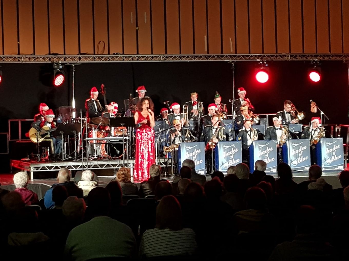 RAF Shades of Blue Big Band perform a Christmas concert wearing uniform and Christmas hats.