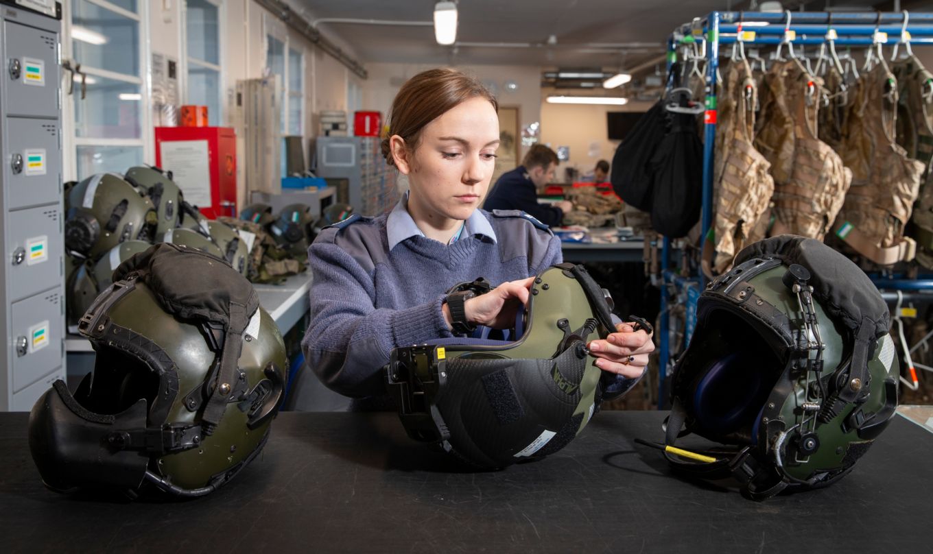 Senior Aircraftman Gabrielle Watt prepares helmets for use in the Survival Equipment Section