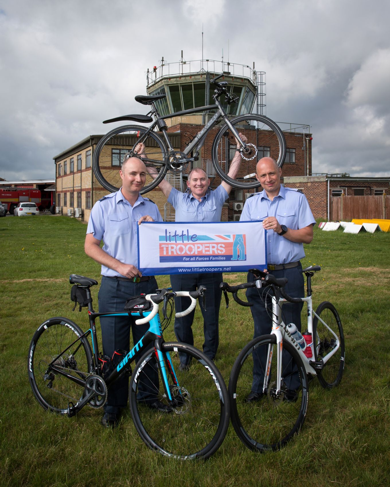 The three Air Traffic Controllers pose with their bikes at the Control Tower before the expidition