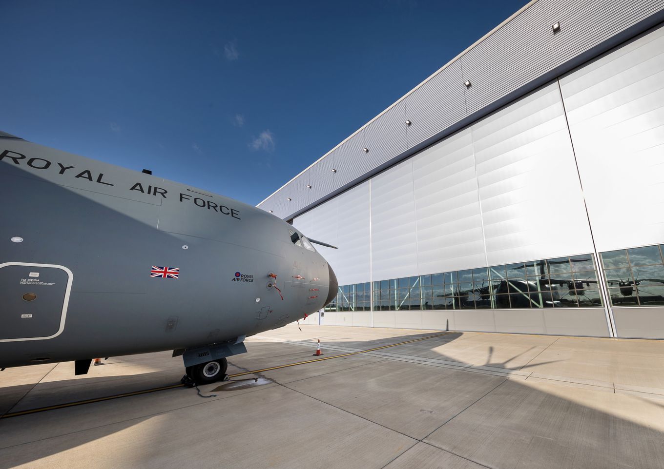 An A400M Atlas aircraft parked outside the new hangar at RAF Brize Norton