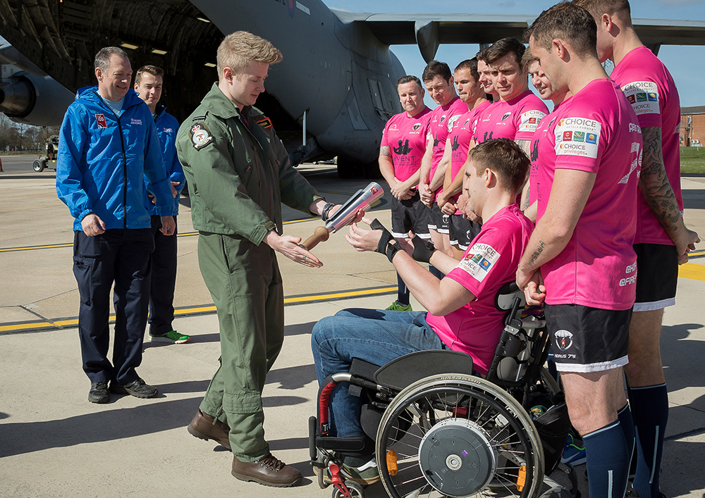 The RAF100 Baton Relay Team passed the Baton to Corporal Rob Bugden, an injured Parachute Jumping Instructor, and the Horus 7’s Rugby team