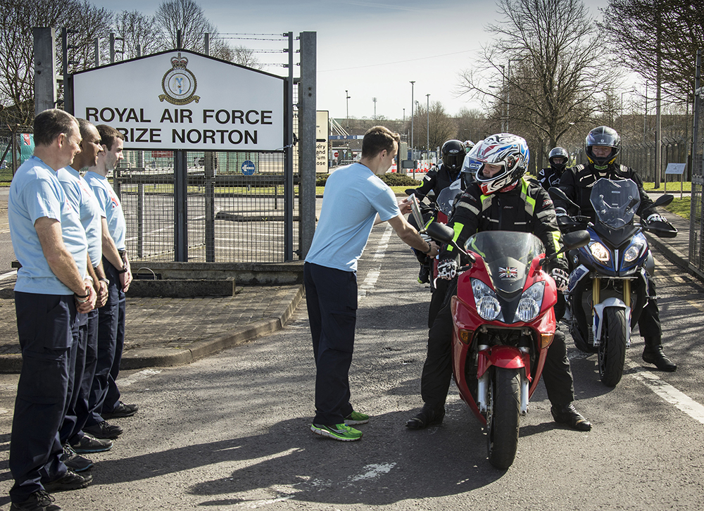 The RAF Brize Norton Motorcycle Club return the baton to the RAF100 Relay Team for the next leg of its journey around the UK and abroad ,