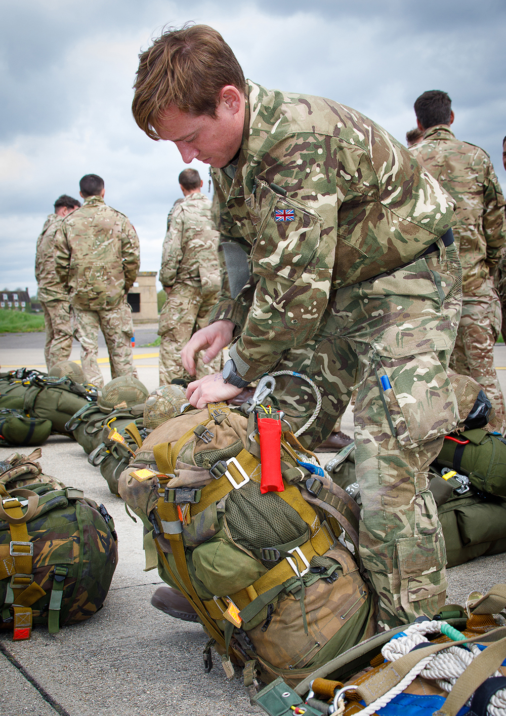 A Parachute Training Squadron Senior NCO carrying out parachute checks