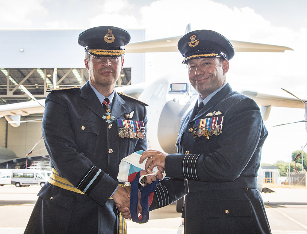 Air Vice-Marshal Cooper presented the Station Commander's pennant to Group Captain James