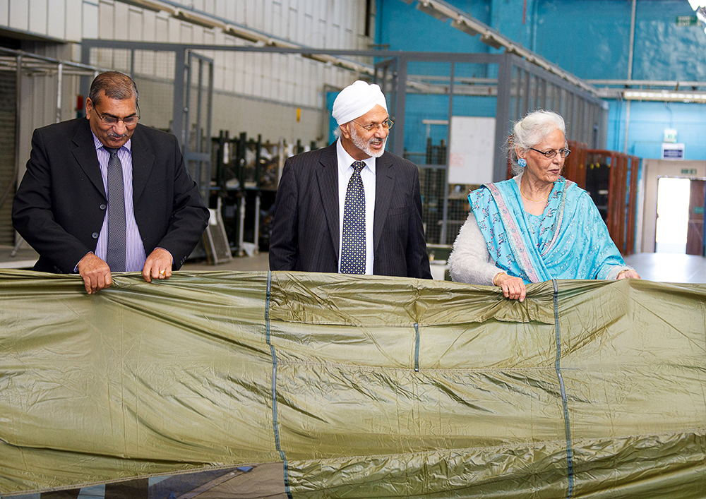 The guests are pictured enjoying a tour of the facilities and equipment in the Parachute Training Squadron hangar
