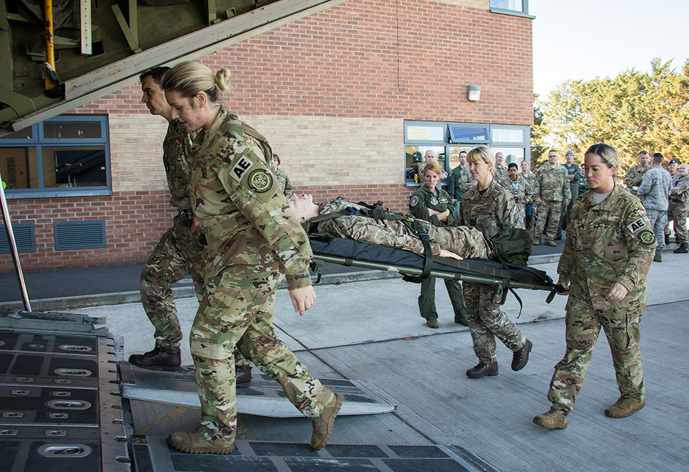 UK and US Medical Reservists carry a patient from the Ambulance onto the Rear Crew Trainer