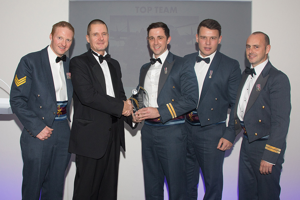 Mr Geoff Adams, Director of Station Engineering and Support for Babcock Aviation presents the Top Team award to Op RUMAN Tactical Air Traffic Control