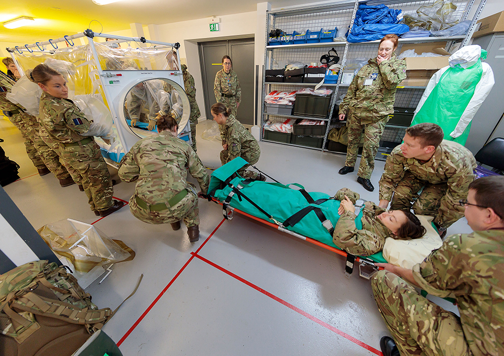 A team of Medical professionals prepare the patient to be loaded