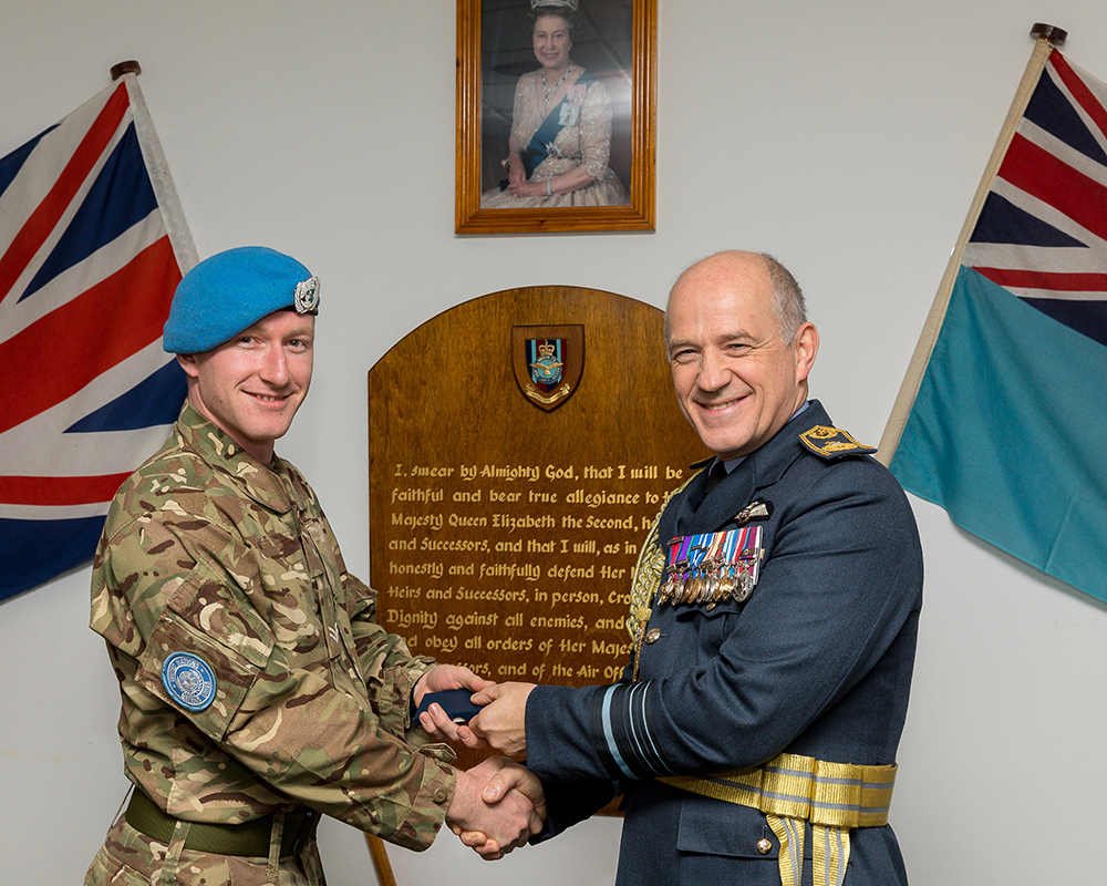 Corporal Parkes, Theatre Nurse, Operation TRENTON 5 receiving his UN Medal from Air Marshal Atha, Deputy Commander Operations