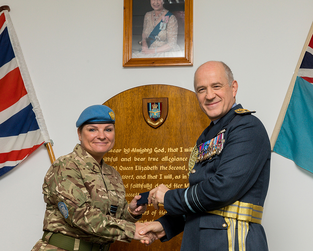 Air Marshal Atha, Deputy Commander Operations, presenting a UN Medal to Flight Lieutenant Vanner, Senior Nursing Officer, Operation TRENTON 5