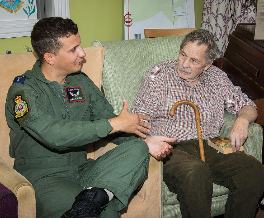 Senior Aircraftman Alex Lapchuk of No. 10 Squadron, RAF Brize Norton, chats with Mr Jonathon Malcolm, whose uncle had been a pilot in the RAF during the Second World War