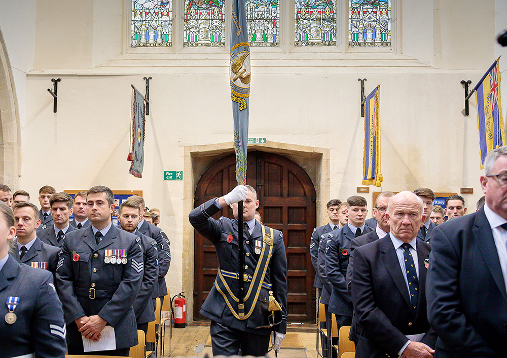 Members of No II Squadron RAF Regiment bring the Squadron Standard to the front of the church ready to be laid