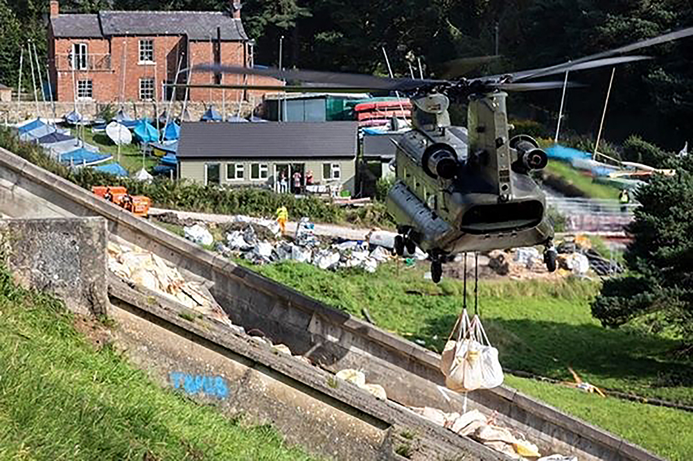 A No. 27 Squadron CH-47 Chinook helicopter from RAF Odiham helping in efforts to stabilise ?the Toddbrook Dam, Whaley Bridge